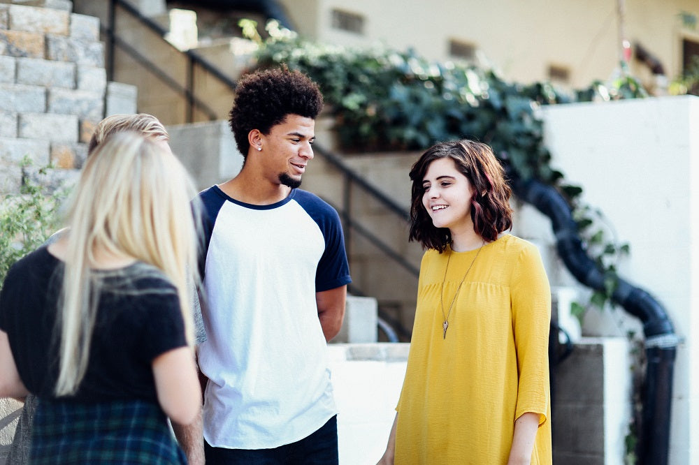 Casually dressed, diverse group of friends chatting.