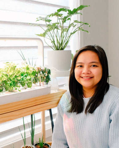 Woman posing with the Smart Garden 9.