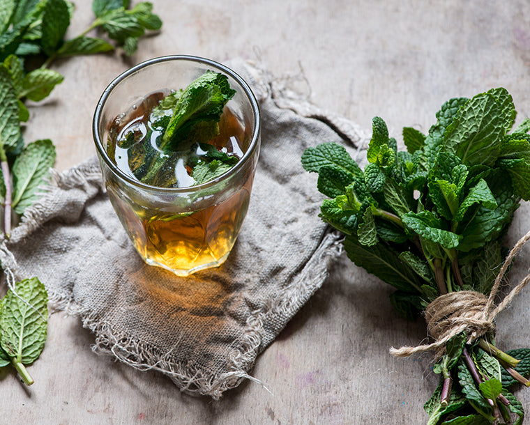 Herbal tea in a glass on a table.