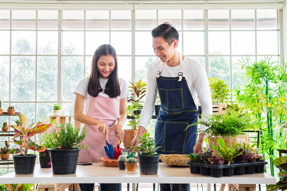 Happy, young couple gardening together.