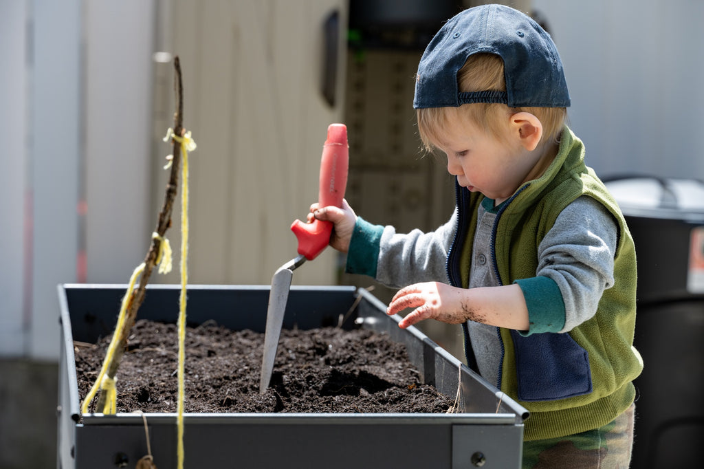 Toddler working in the garden.