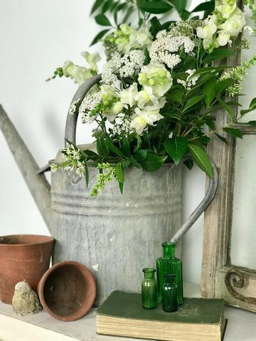 Flowers displayed in a watering can.