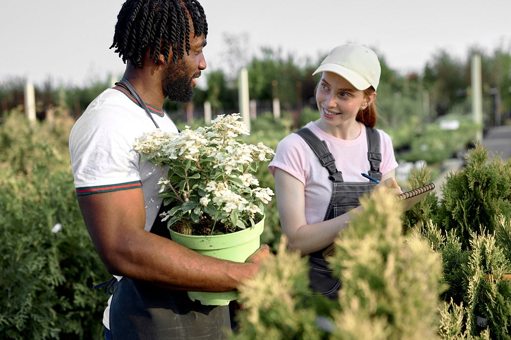 Young, diverse couple talking together in a garden.