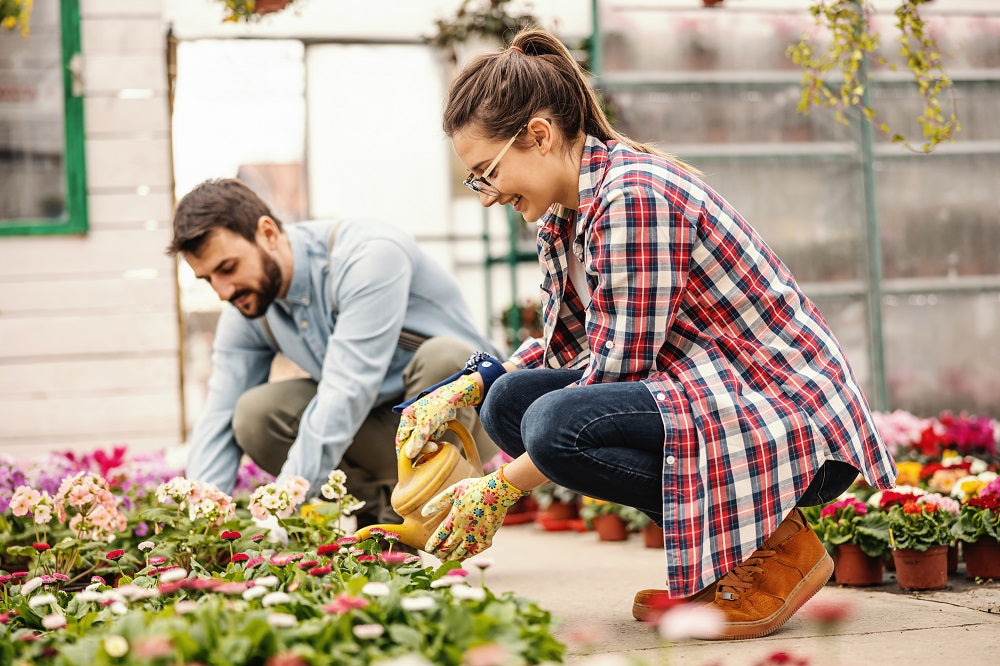 Young millennial couple gardening together.