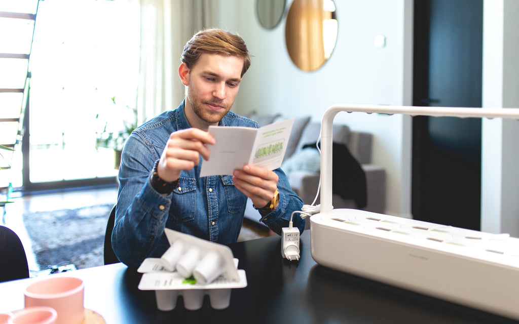 Man reading Smart Garden 9 setup instructions.