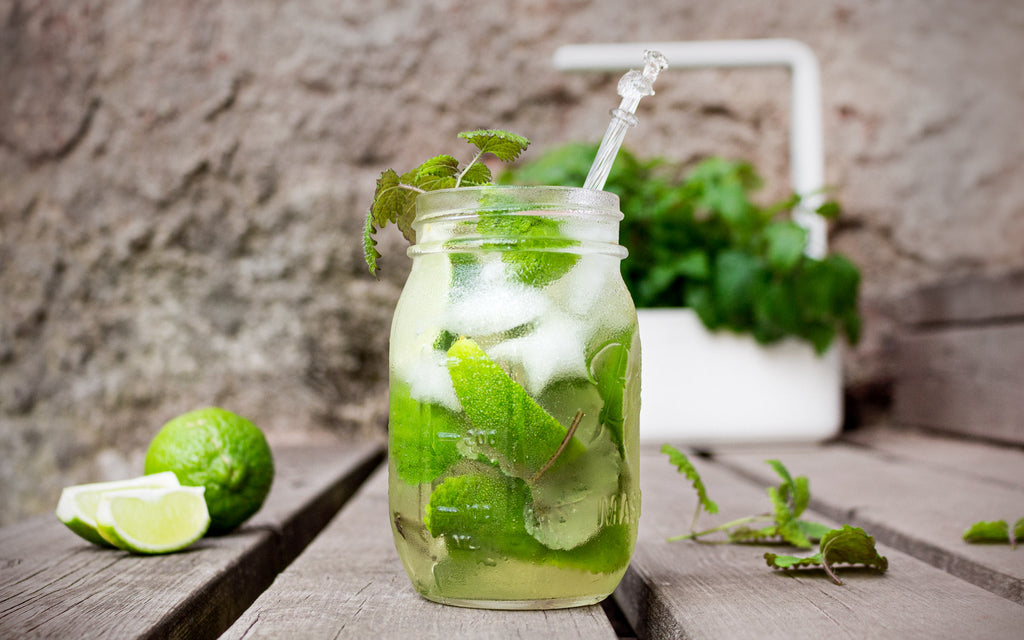 A jar of lemon balm lemonade in front of a Smart Garden 3.