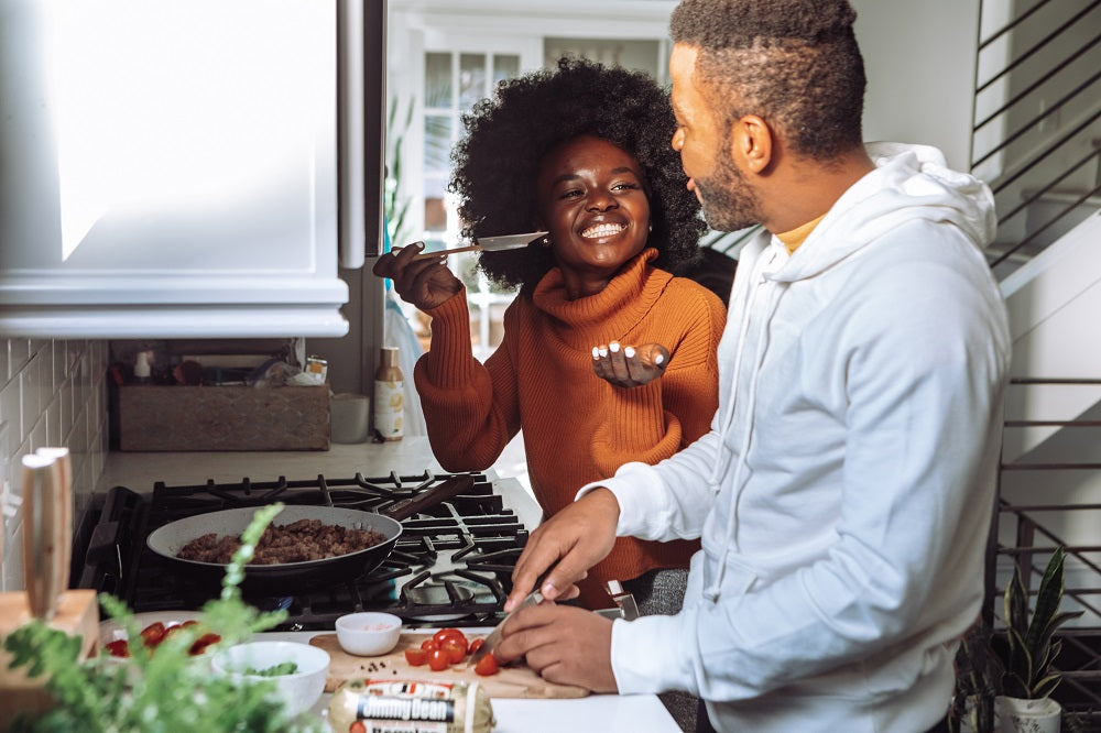 Happy couple cooking together in the kitchen.