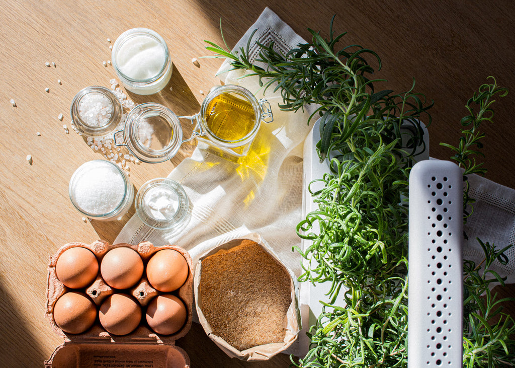 Baking ingredients and the Click & Grow Smart Garden 3 on a wooden table.