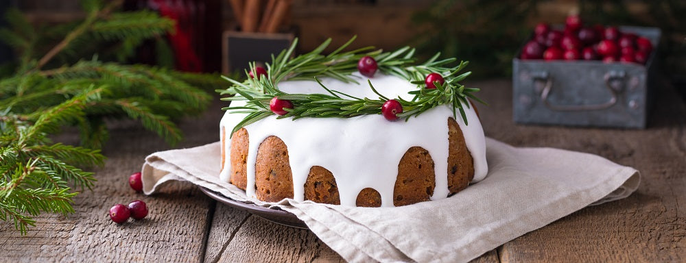 Christmas cake decorated with a rosemary wreath.